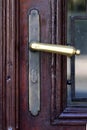 Old brass handle of a wooden door Royalty Free Stock Photo