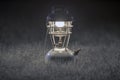 Old brass kerosene lamps,Antique brass lamp,Night camping lantern, on Gray grass background.soft focus.Monotone image form Royalty Free Stock Photo