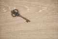 Old brass key on the wooden table. Royalty Free Stock Photo