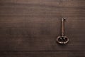 Old brass key on wooden table Royalty Free Stock Photo