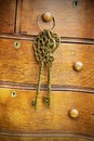 Old Brass Keys Hanging on Antique Bureau Dresser Drawer Pull