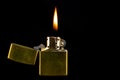 Old Brass Lighter and Flame on a Black Background Royalty Free Stock Photo