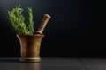 Old brass mortar with fresh rosemary branches