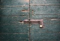 Old Brass Padlock on Wooden Green Gate Royalty Free Stock Photo