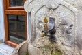 Old brass water tap and an ancient stone wash basin Royalty Free Stock Photo
