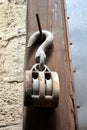 Old braun pulley on the wall Royalty Free Stock Photo