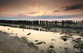 Old breakwater on coast at sunset Royalty Free Stock Photo
