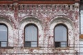 old brick apartment building with badly pealing paint