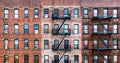 Old brick apartment buildings with windows and fire escapes along Second Avenue in the Upper West Side of Manhattan, New York City