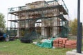 Old brick arch. Entrance gate to the old manor. Arch in the scaffolding for restoration work. Bricks lie nearby Royalty Free Stock Photo