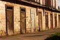 Old brick barn with lots of wooden doors Royalty Free Stock Photo