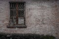 An old brick building with a barred window Royalty Free Stock Photo