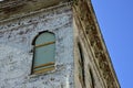 Old brick building with corbels and peeling paint