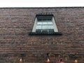Old brick building facade holiday lights vintage windows looking up Royalty Free Stock Photo