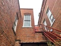 Old brick building facade holiday lights vintage windows and stairs