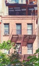 Old brick building with fire escape in New York City, color toning applied, USA Royalty Free Stock Photo