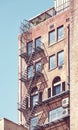 Old brick building with fire escape in New York City, color toning applied, USA Royalty Free Stock Photo