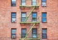 Old brick building with green fire escape, New York City, USA Royalty Free Stock Photo