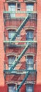 Old brick building with iron fire escape, color toning applied, New York City, USA Royalty Free Stock Photo