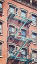 Old brick building with iron fire escape, color toning applied, New York City, USA