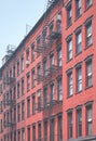 Old brick building with iron fire escape, color toning applied, New York City, USA Royalty Free Stock Photo