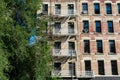 Old Building on the Lower East Side in New York City with Fire Escapes next to a Green Tree Royalty Free Stock Photo