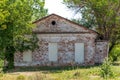 An old brick building with sealed doors without windows. The countryside is a spring landscape. Royalty Free Stock Photo