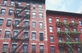 Old brick buildings with fire escapes, color toning applied, New York City, USA Royalty Free Stock Photo