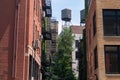 Old Brick Buildings with Fire Escapes and Water Towers in a Manhattan Alley on the Lower East Side of New York City Royalty Free Stock Photo