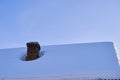 Old brick chimney on house roof covered with snow Royalty Free Stock Photo