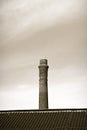 Old brick chimney isolated on sky - sepia toned Royalty Free Stock Photo