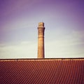 Old brick chimney isolated on sky - toned image Royalty Free Stock Photo