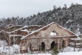 Old brick destroyed building in winter. Top view, the building without a roof of red brick, it is snowing.