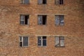 Soviet architecture. A collapsing brick wall with broken and open windows Royalty Free Stock Photo