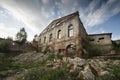 The old brick facade of the building of the 19th century, destroyed by all the winds, under the open blue sky. atmospheric photo Royalty Free Stock Photo