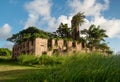 Old brick factory decaying in countryside gets overgrown by tropical vegetation Royalty Free Stock Photo