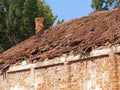 Broken roof of an old brick house