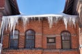 Old brick house with large icicles