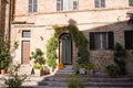 An old brick house of a medieval italian village with ornamental plants and flowers in the court yard Italy, Europe Royalty Free Stock Photo