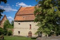 An old brick house with orange tile roof in Strzegomiany village, Poland.