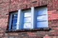 Old brick house with vintage blue and white windows Royalty Free Stock Photo