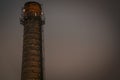 Old brick industrial chimney in the dark. A chimney of the Soviet era Royalty Free Stock Photo