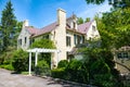 An old brick mansion in the American Colonial style. Fireplace chimneys and pergola at the entrance Royalty Free Stock Photo