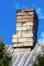 Old brick messy cracked chimney of house