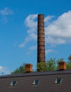 Old brick pipe of the boiler house and the roof of the building Royalty Free Stock Photo