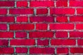 Old brick red wall. Brick background. Dark pink cracked paint on a brick. Soft focus. Royalty Free Stock Photo