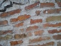 Old brick. The restored wall of the building of Roman times. Sunlight and warm brown-red shades of uneven bricks. Archaeological