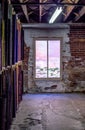 Old brick room with lit window and broken cement floor Royalty Free Stock Photo