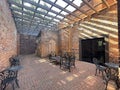 Old brick rustic building looking inside chairs and tables Royalty Free Stock Photo