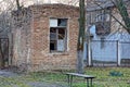 Old brick shed with a broken window in the courtyard